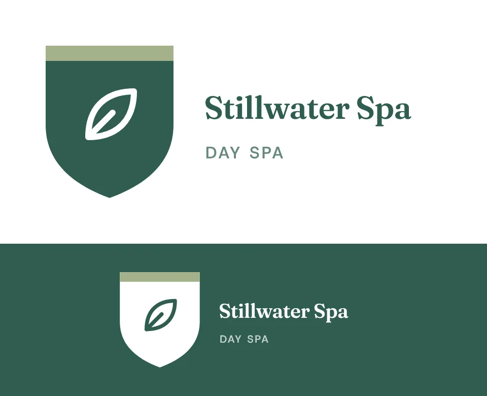Day spa logo concept for Stillwater Spa: a shield emblem with a leaf, shown on white and on its own colour